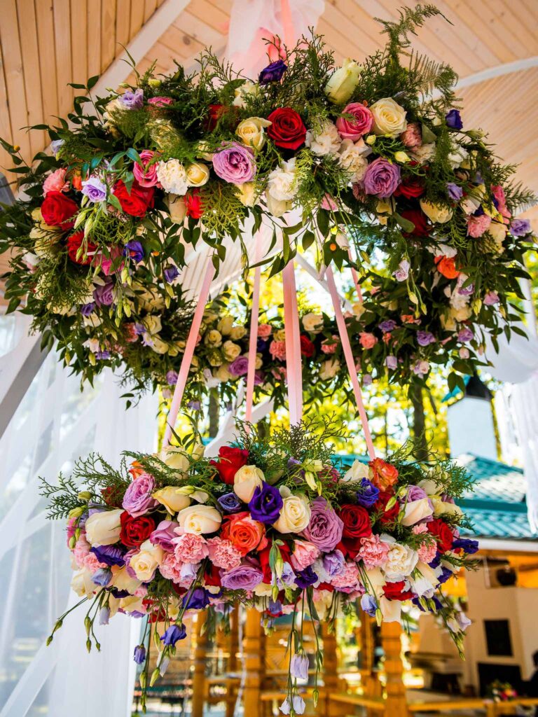 A floral chandelier hanging from a ceiling